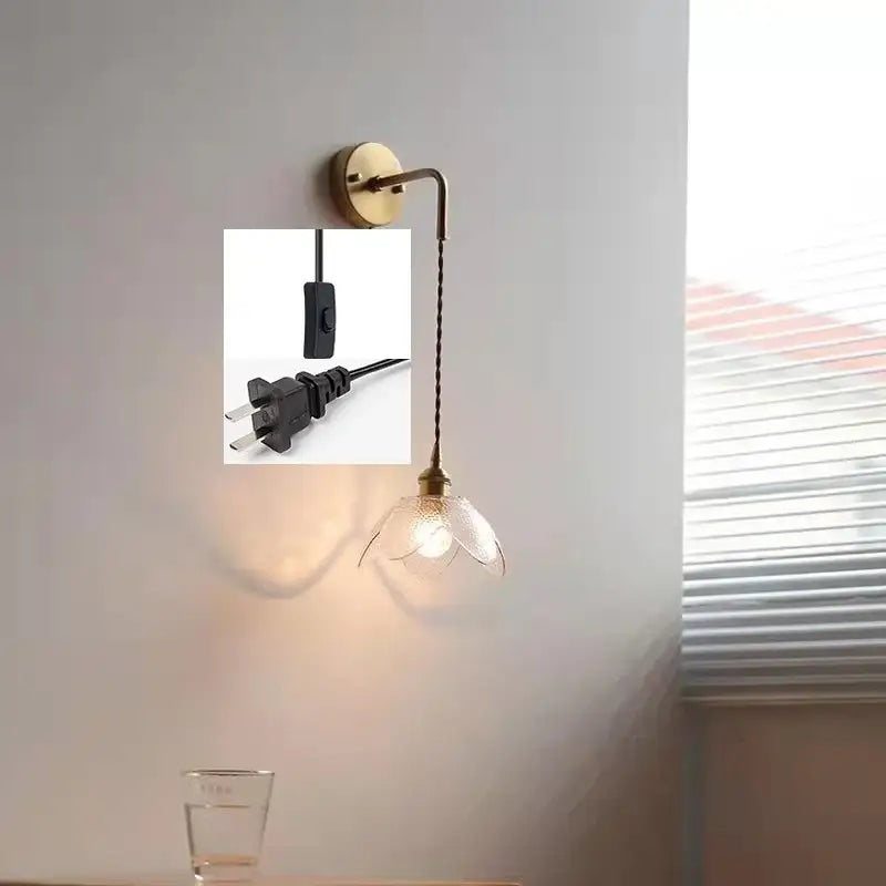 Brass wall lamp with gray glass led flower-shaped shade and twisted cord for bathroom use