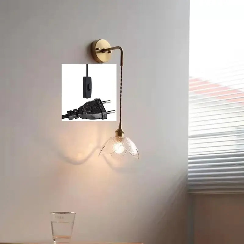 Brass wall lamp with gray glass led flower shade and black corded plug for glass led bathroom lighting
