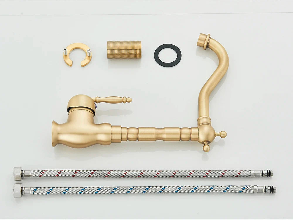Antique brass deck mounted kitchen faucet with rotating neck and ornate vintage-inspired hardware components