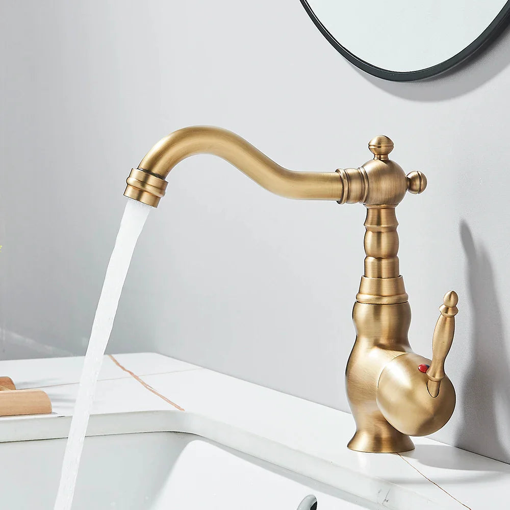 Antique brass finished deck mounted single handle kitchen faucet with rotating neck and vintage curved spout design