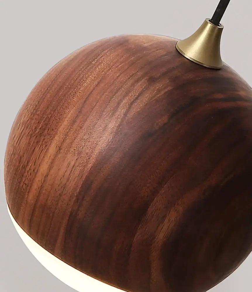 A sleek round wooden wall lamp with warm brown led walnut wood finish and brass hardware for bedroom decorbites