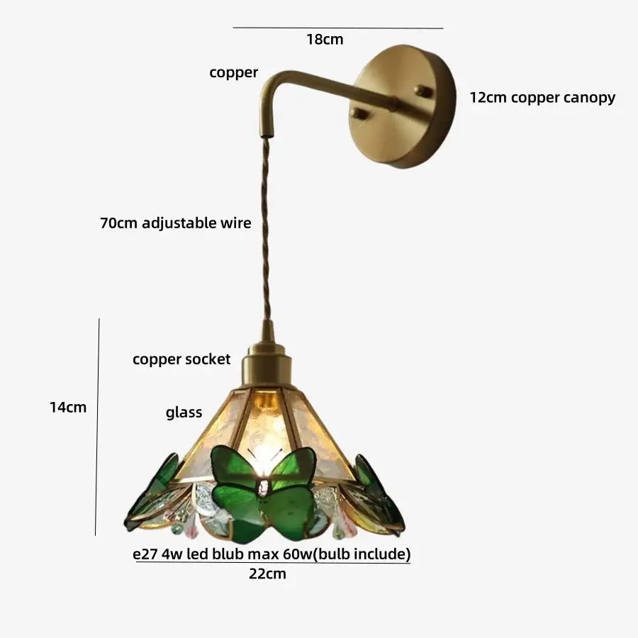 Antique brass-finished copper wall light fixture with orange butterfly stained glass shade and clear crystal accents