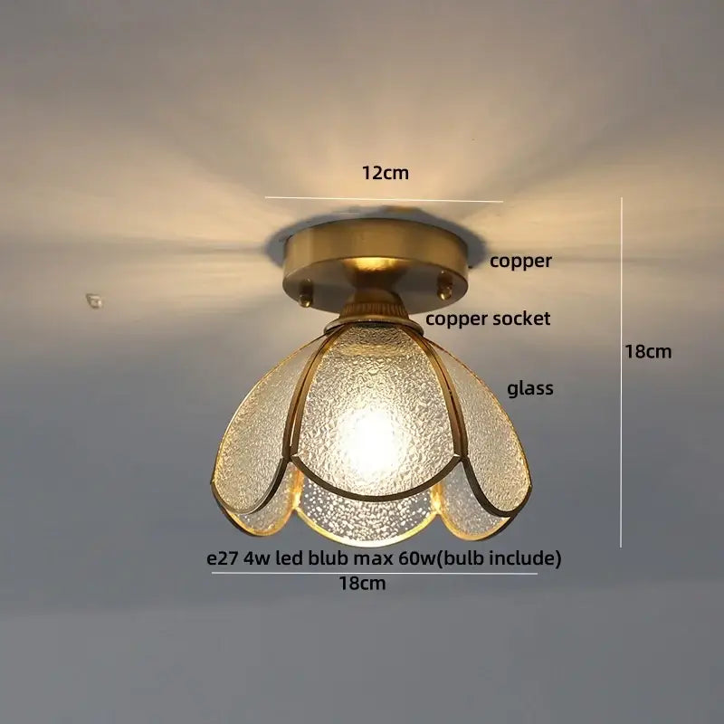 A warm-toned brass red butterfly glass led ceiling light with copper socket and textured petals for bedroom decor