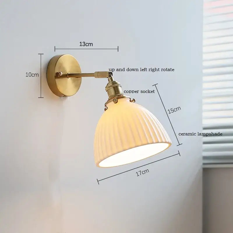 Vintage-style wall sconce with brass-finished copper socket iron arm and ribbed off-white decorbites ceramic shade