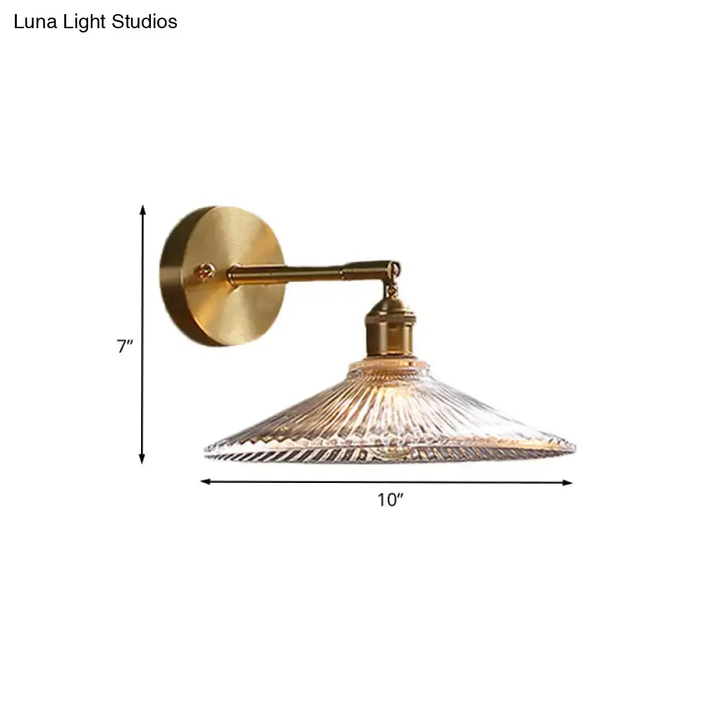 Brass scalloped bedside sconce light fixture with clear ribbed glass shade for bedroom wall lighting