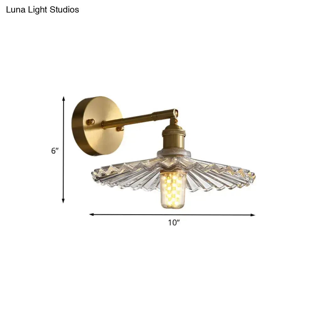 Brass scalloped bedside sconce light with faceted glass shade and exposed edison bulb sconce light fixture for bedroom