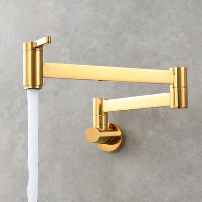 Brass wall mounted pot filler kitchen faucet with a gold-colored sleek extendable articulated gooseneck arm