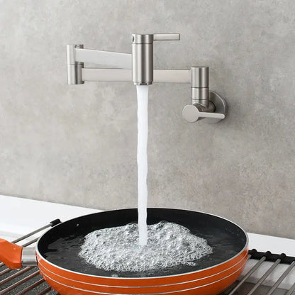 Brass wall mounted pot filler kitchen faucet with brushed stainless steel finish and articulated gooseneck pouring water