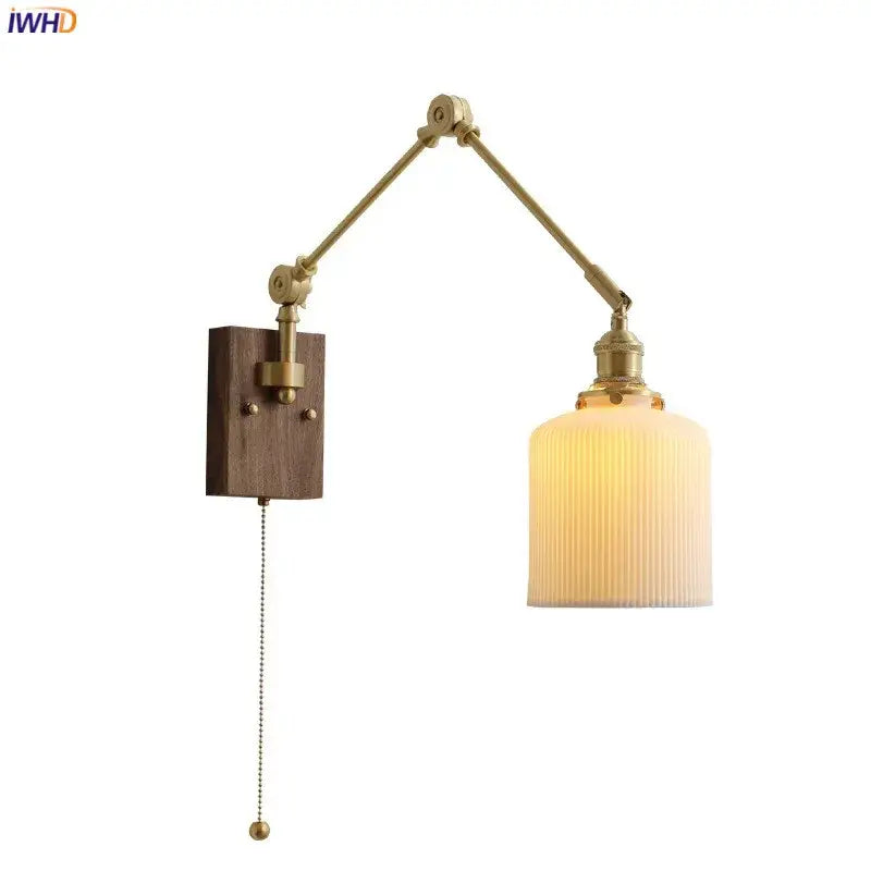 Brass adjustable wall sconce with copper swing arm, ribbed cream glass shade, and wooden mounting plate for bedroom lighting