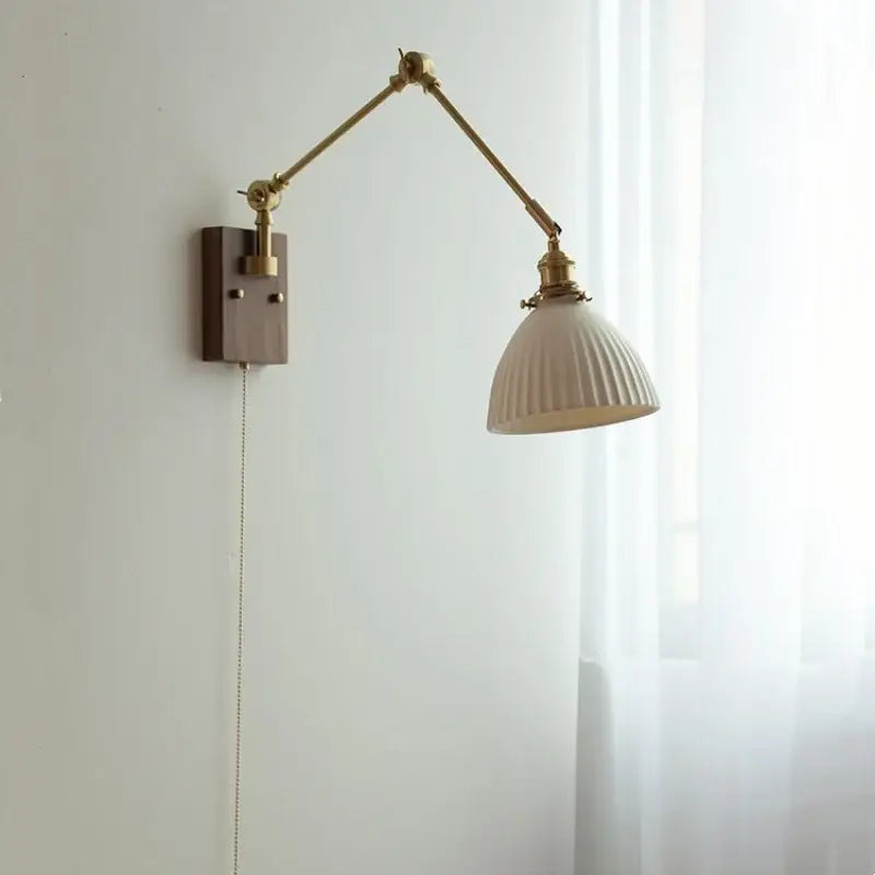 Brass walnut wall light with cream ribbed ceramic ball brass shade and adjustable arm for bedroom decorbites wall light