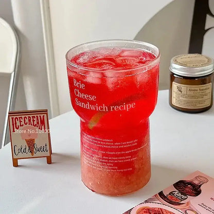 Brie cheese sandwich printed clear glass coffee mug filled with red iced drink and white text with straw