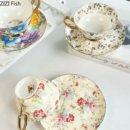 Delicate porcelain teacup and saucer dining set with brilliant flowers pattern in soft pastels and gold rims