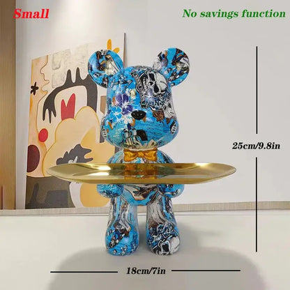 Blue vinyl bear figurine with gold bow tie on golden tray british flag and floral decorbites graffiti bear key tray