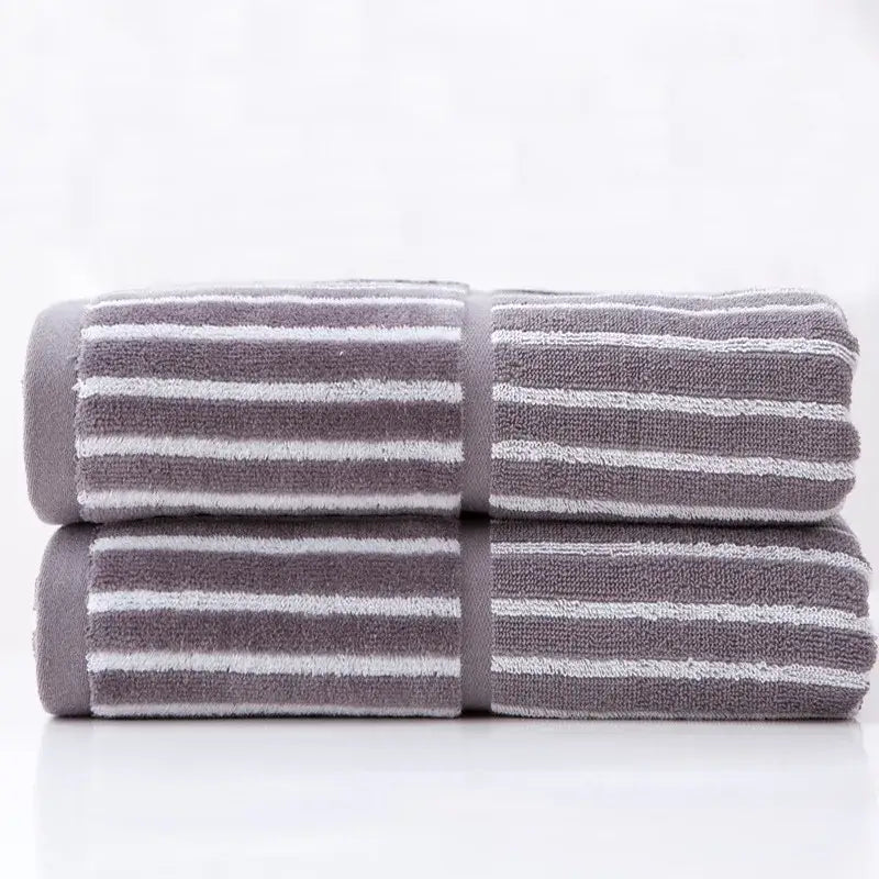 Stacked gray and white striped sports fitness towel with soft textured weave for gym and fitness use