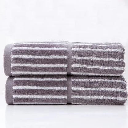 Stacked gray and white striped sports fitness towels with a soft textured weave for gym accessory use