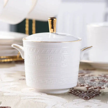 White ceramic sugar bowl from british white tea set with gold trim and embossed greek key pattern decorbites bone