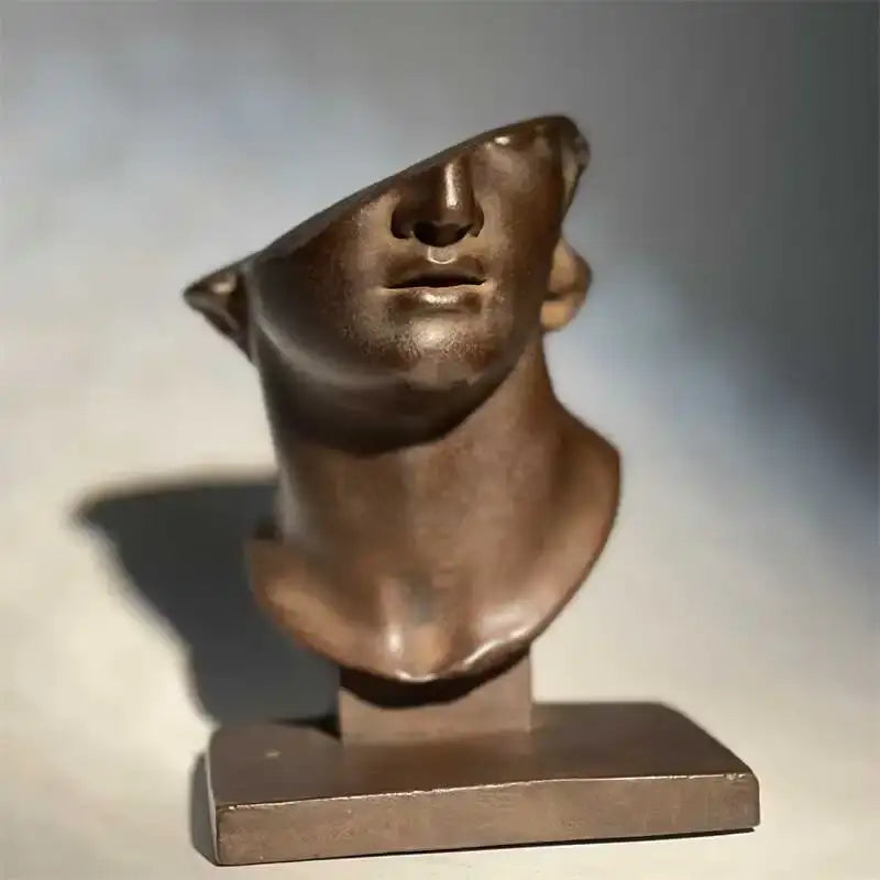 Bronze abstract human face sculpture with tilted angular features on rectangular base for living room decorbites decor