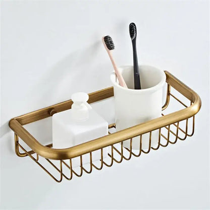 Bronze and white ceramic bathroom accessories set with gold-toned wire caddy holding ceramic cup and frosted soap dispenser
