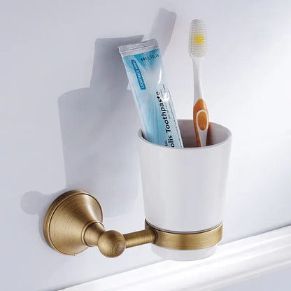 White ceramic toothbrush holder with brass metal bracket and accent band from decorbites bronze bathroom accessories set