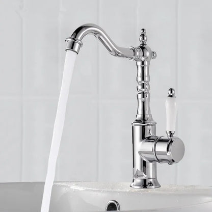 Chrome finished bronze basin faucet with curved spout and off-white ceramic handle for cold water use