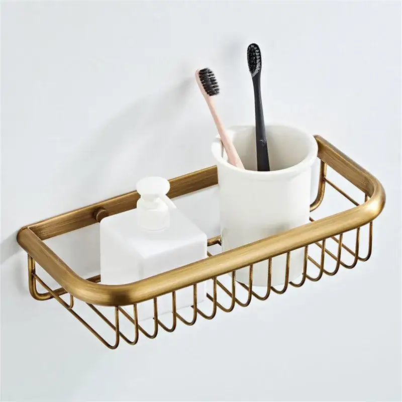 Bronze bathroom hardware set with gold-toned metal caddy woven design holding ceramic cup and frosted soap dispenser