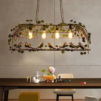 Bronze birdcage pendant lights with exposed bulb lighting and hanging greenery for dining room decorbites pendant lights