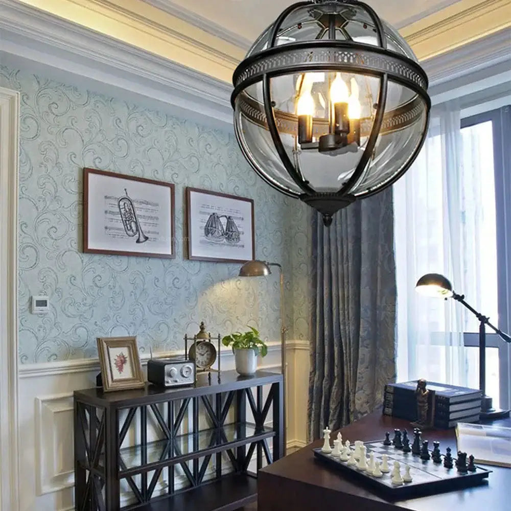 Bronze black glass globe chandelier foyer light featuring a vintage spherical pendant with black metal frame and warm bulbs