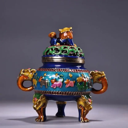 A vibrant blue and gold bronze cloisonne lion incense burner with intricate animal motifs and dragon handles for decorbites decor