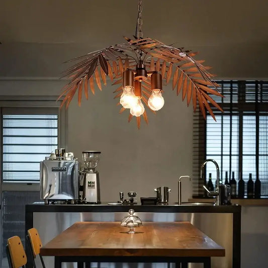 Bronze coconut tree pendant lamp with bronze-colored metal leaf design and three exposed bulbs for dining room decorbites bronze coconut