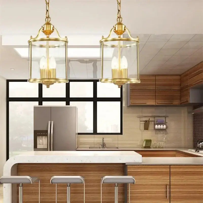 Pair of decorbites bronze glass pendant lights with brass lantern-style frames and clear glass for dining room decor