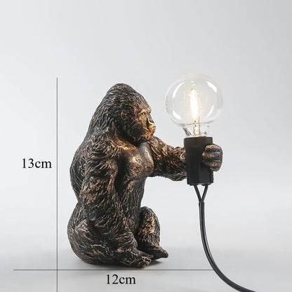 Bronze finished king kong gorilla table lamp holding a clear glass bulb with black base and cord for bedroom decorbites king kong