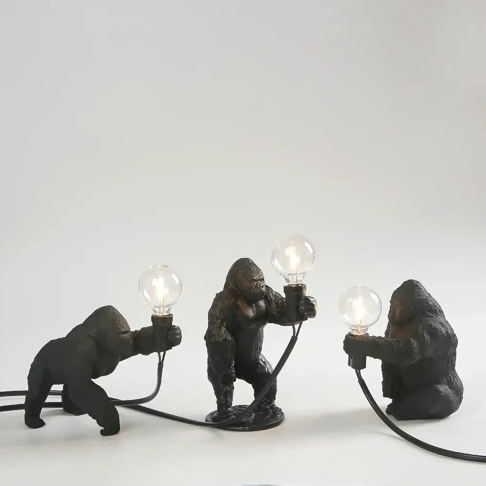 Three black bronze king kong gorilla table lamps holding glowing bulbs ideal for bedroom night light decorbites king kong