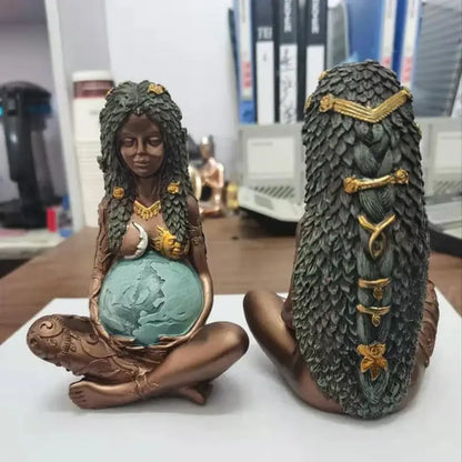 Bronze mother earth goddess figurine with intricate gold-accented hair holding a teal globe for living room decor