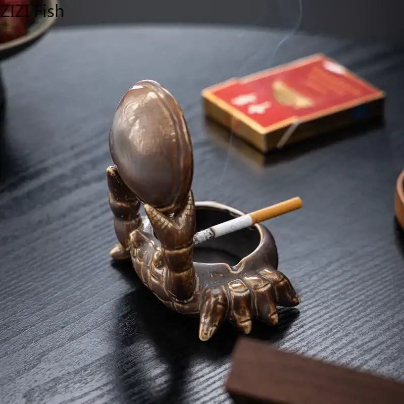 Brown decorbites crab ceramic ashtray and phone holder featuring a bronze lobster-shaped ceramic design with detailed claws and smooth shell