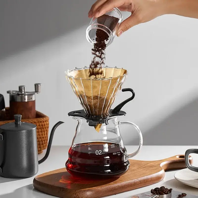 Clear glass pour-over coffee dripper with gold-toned metal filter and black base for coffee cone filter decorbites accessory