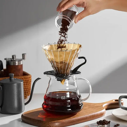 Clear glass pour-over coffee dripper with gold-toned metal filter and black base for coffee cone filter decorbites accessory