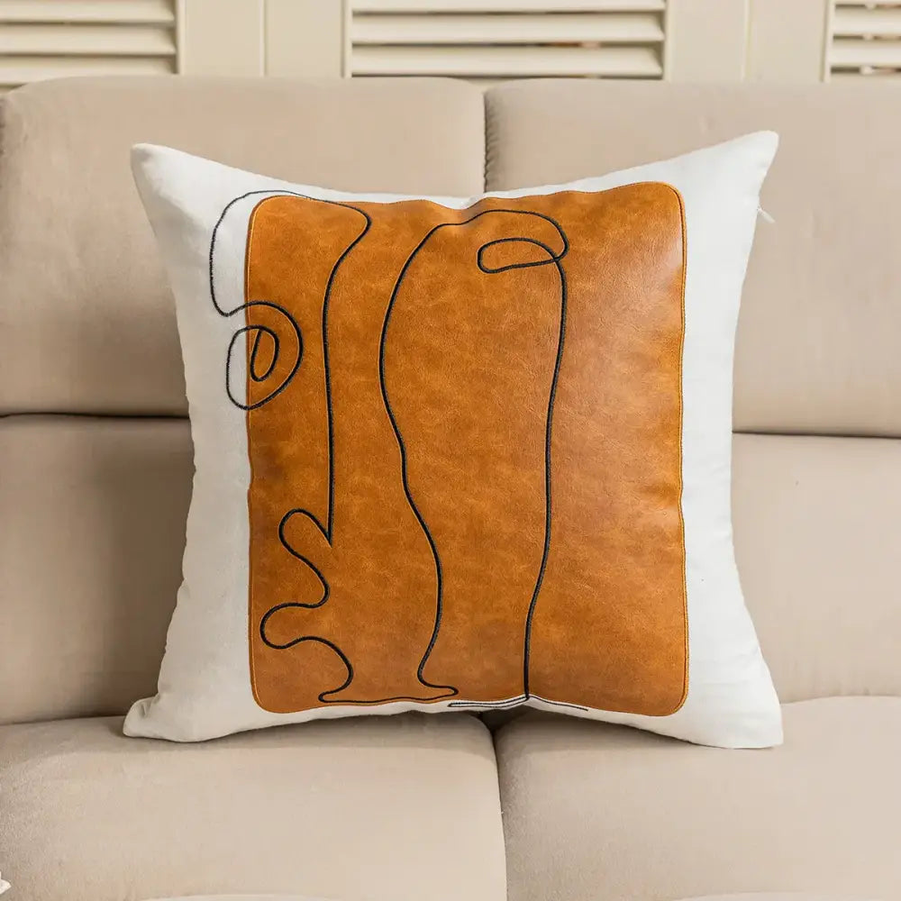 Brown and white geometric embroidery plush cushion cover with white fabric base and orange faux leather panel decorbites geometric embroidery