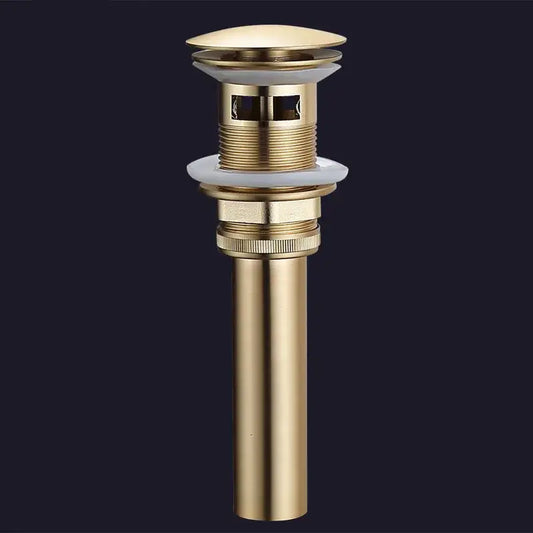 Brushed gold and white ceramic bathroom sink drain assembly kit with sleek cylindrical brass drain and integrated stopper