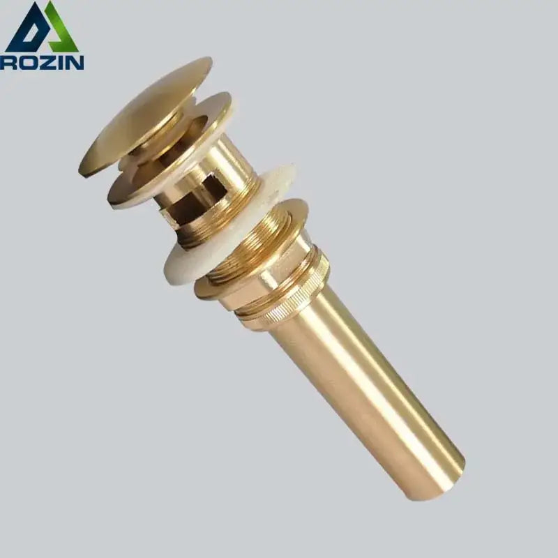 Brass-colored cylindrical brushed gold basin sink drain with flared top and threaded base from decorbites brushed gold collection