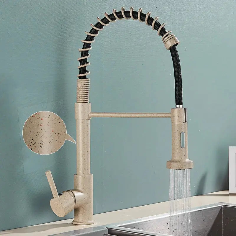 Beige speckled kitchen faucet with flexible black-coated hose and pull-down spray head for versatile use
