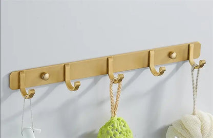Brushed gold metal wall-mounted robe hooks rack with five hooks and round decorative knobs by decorbites brushed gold