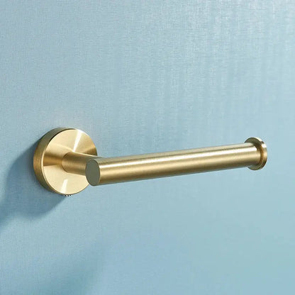 Brass-finished toilet paper holder with cylindrical design and circular base in brushed gold stainless steel bathroom accessories set