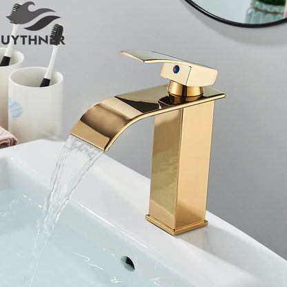 Brushed golden single hole basin faucet with waterfall design and blue accent lever for elegant bathroom sinks
