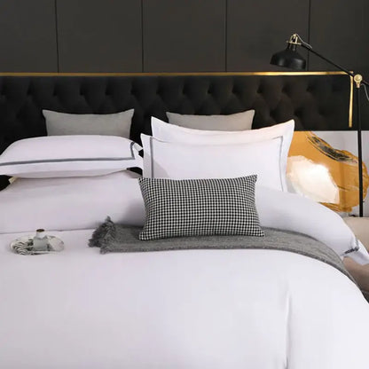 Black tufted headboard with gold trim featured in decorbites brushed hotel style white and gray bedding sets room
