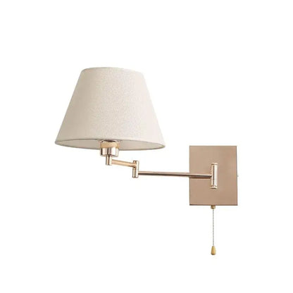 A sleek matte brass wall lamp with adjustable rocker arm and cream fabric shade for living room lighting