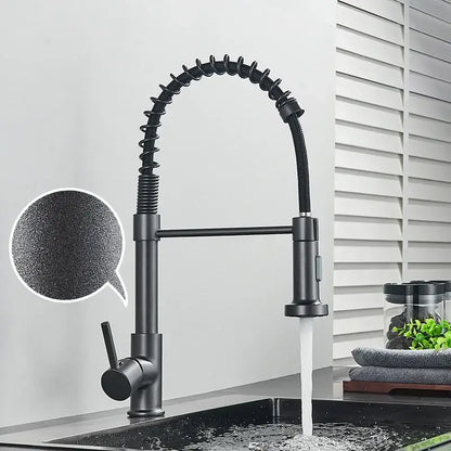 Black matte kitchen faucet with flexible coiled hose and pull-down spray head in brushed nickel decorbites style