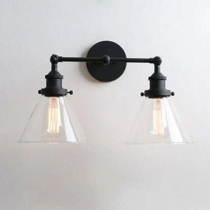 Black wrought iron wall lamp with two clear funnel glass metal conical shades and exposed filament bulbs for decorbites funnel glass decor