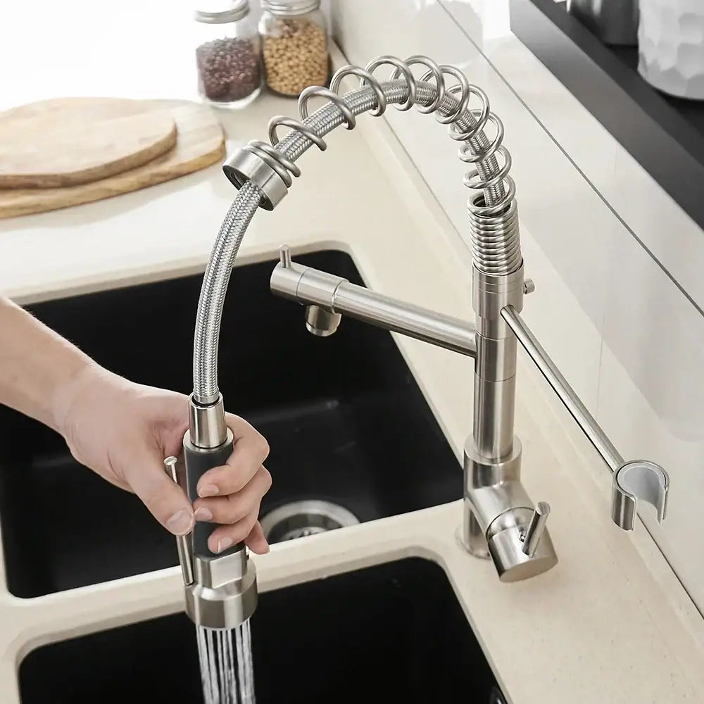Brushed nickel kitchen faucet with a stainless steel pull-down swivel water outlet and flexible coiled hose design