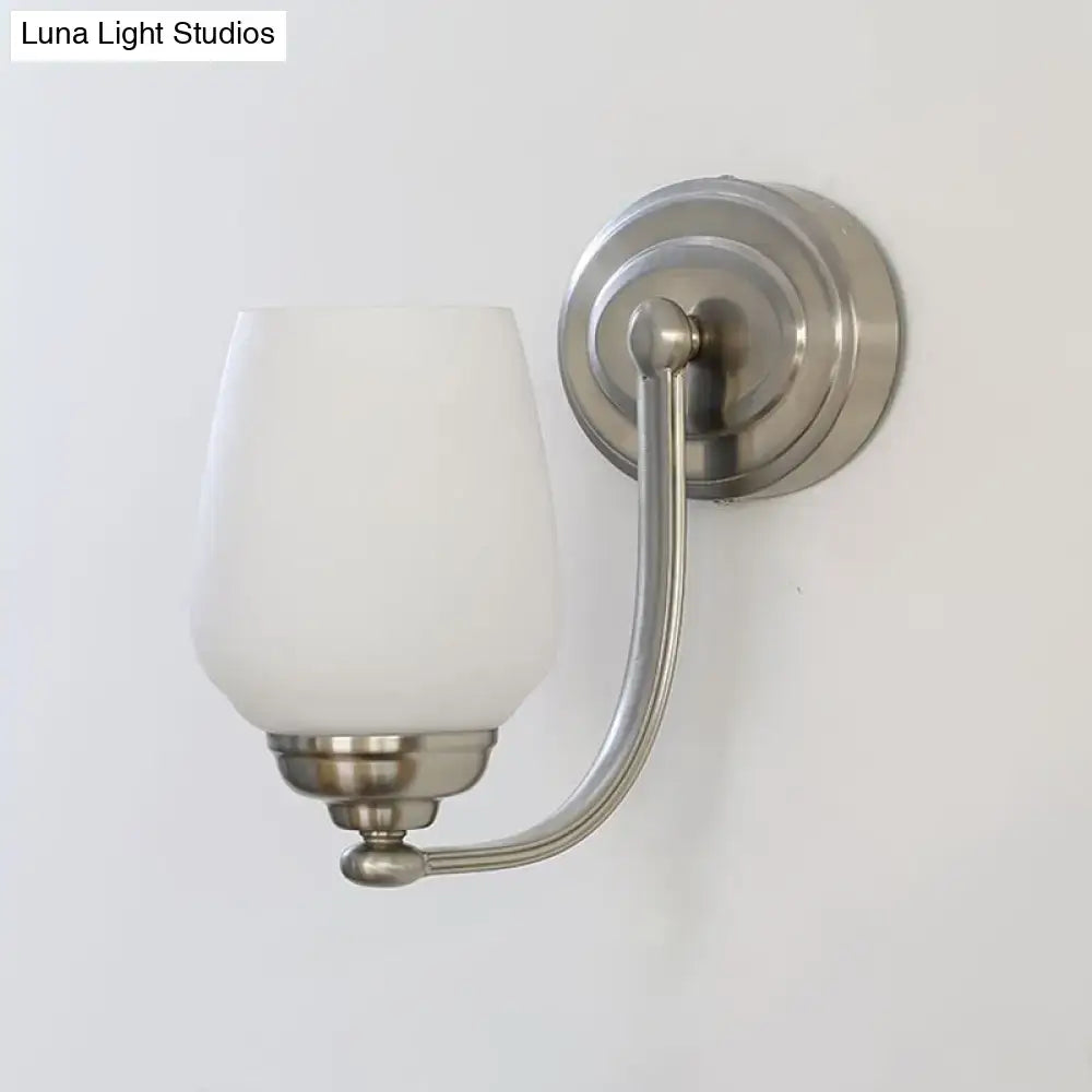 Brushed nickel wall lamp with sleek milk glass shade designed for stairways lighting and decor