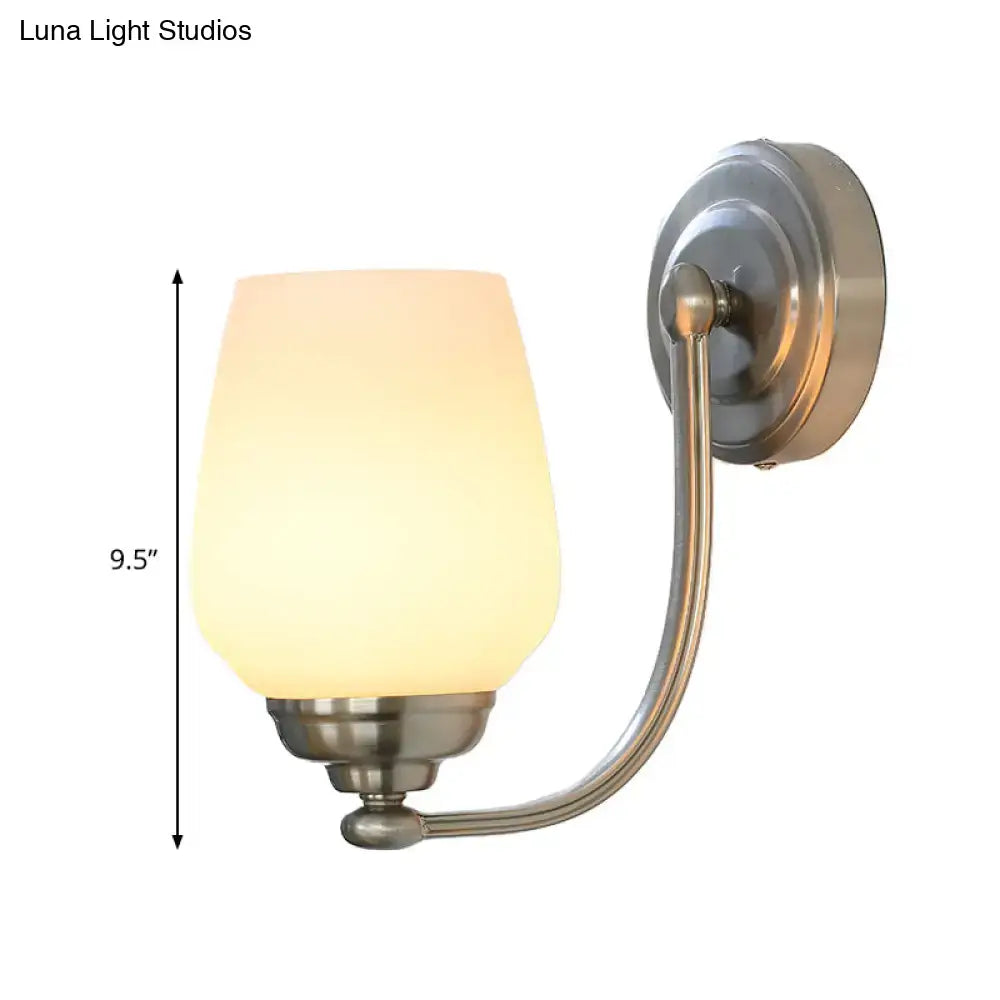 Brushed nickel wall lamp with warm frosted milk glass shade designed for stairways and indoor lighting